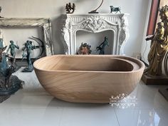 a bath tub sitting on top of a white tiled floor next to statues and mirrors