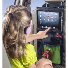 This vinyl pocket tablet holder allows touch screen access, with two pockets to store cords, snacks and games. Color: Black. Laptop Stand Wood, Stroller Storage, Transparent Screen, Car Console, Car Seat Organizer, Ipad Holder, Console Organization, Tablet Holder, Travel Storage