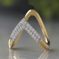 a close up of a diamond ring on a table