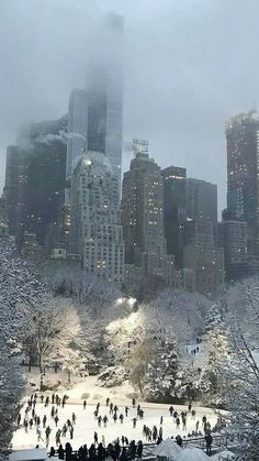 people are skating in the snow near tall buildings