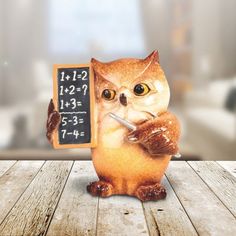 an owl figurine holding a chalkboard that says it's 2 25