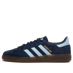 The adidas Handball Spezial Shoes in the Navy Gum colorway are a timeless blend of sporty elegance. Originally designed for elite handball players in 1979, these sneakers have become a style icon. Crafted with a supple suede upper, they exude classic chic. The signature three light blue stripes adorn the sides, while the soft gum rubber outsole pays homage to their vintage roots. Whether you’re a football fan or a fashion enthusiast, the Handball Spezial Shoes offer comfort and style. Step into Cute Trendy Sneakers, Navy Adidas Shoes, Navy Adidas Samba, Adidas Shoes Women Blue, Navy Blue Spezial Adidas, Adidas Shoes Sambas, Shoes For Christmas List, Adidas Gizzel, Trending Adidas Shoes