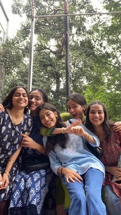 a group of young women standing next to each other in front of a ropeway