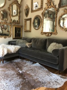 a living room filled with furniture and lots of mirrors