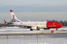 an airplane is taking off from the runway in the snow with trees in the background