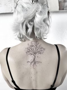 a woman with a tattoo on her back