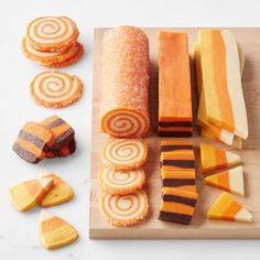 a wooden cutting board topped with different types of candy