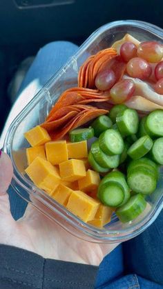 a plastic container filled with lots of different types of vegetables and cheese on top of each other