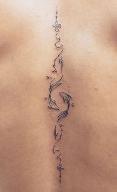 the back of a woman's stomach with an arrow tattoo on her left side