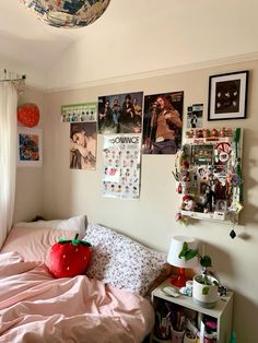 a bedroom with posters on the wall and a bed