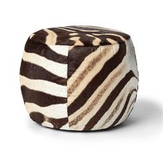 a zebra print ottoman sitting on top of a white floor