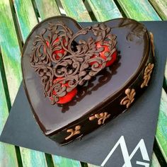 a heart shaped chocolate cake sitting on top of a table