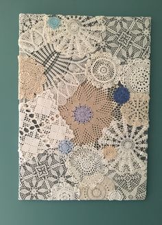 a piece of art that is made out of doily and paper with flowers on it