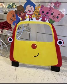 a toy car with many cartoon characters on it