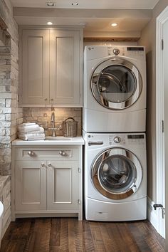 a washer and dryer in a small room with wood flooring on the wooden floors