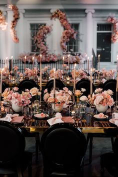 a long table is set with flowers and candles for a formal dinner or reception in an elegant setting