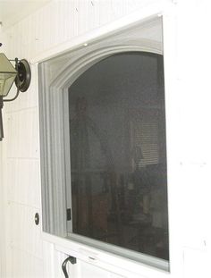 a screen shot of a window on the side of a wall with a light attached to it