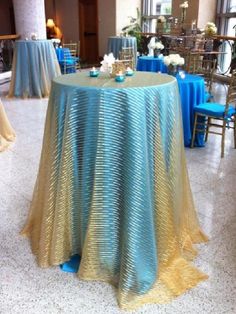 a round table covered in blue and yellow cloths