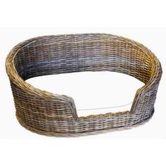 a round wicker basket with an oval handle on the top and bottom, made out of