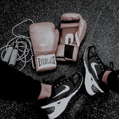 a pair of feet with boxing gloves on the ground