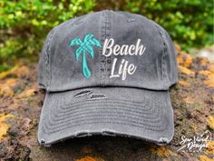 Save 15% off your first purchase by signing up at https://signup.sewvividdesigns.com 🌴 This cap features a palm tree embroidered on your choice of cap.  FEATURED CAP: Dark Grey Baseball with a Aqua Palm Tree ✋ Does not include back of cap embroidery.  TO ADD BACK OF CAP EMBROIDERY: add this to your cart too-  https://etsy.me/2CZfOfQ 🧢 Cap Details 🧢 Baseball Style: Distressed 100% Cotton - Pigment Dyed Unstructured Low Profile Closure: Adjustable Metal Buckle Ponytail Style: Women's Fit Distressed 100% Cotton - Pigment Dyed Unstructured Low Profile **Top hole for Ponytail Closure: Adjustable Velcro strap Mesh Baseball Cap: DISTRESSED Mesh Baseball Cap:   55% Cotton / 45% Polyester  Unstructured Front  Low Profile Dad Hat Fit 2.75 inch Brim Closure: Adjustable Snapback Accessories Beach, Cap Embroidery, Summer Hats Beach, Distressed Baseball Cap, Vacation Accessories, Ponytail Hat, Ponytail Styles, Summer Hat, Beach Hat