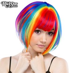 This dramatic, wedge-shaped bob is a popular style among fashionistas! Short in the back and long in the front, it comes with longer bangs, leaving you with endless styling opportunities!   Model: Mynx Midnight Can take heat up to 360 degrees Adjustable Weft Unisex Washable Langer Pony, Long Layers With Bangs, Rainbow Wig, Rainbow Rocks, Wig Party, Halloween Costume Shop, Long Bangs, Bob Wig, Rainbow Hair