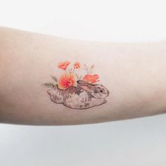 a rabbit with flowers on its head is shown in this tattoo art photo by artist mark taylor