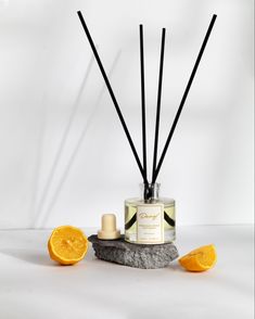 an orange slice next to a candle and some sticks