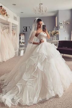 a woman in a wedding dress taking a selfie