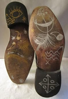 two old shoes with designs on them sitting next to each other