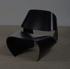 a black chair sitting on top of a carpet