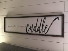 a sign that says we should probably probably cuddle on the side of a wall