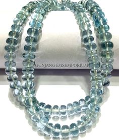 two strands of aqua blue glass beads