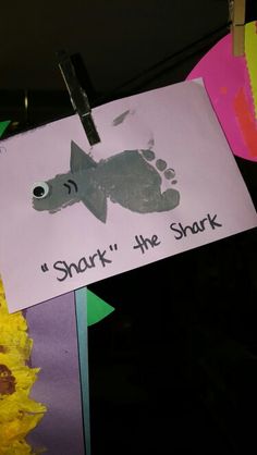 a child's hand and foot print is attached to a sign that says, shark the shrk