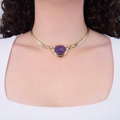 This brilliant necklace is centered with a carved oval amethyst cabochon in a full bezel setting. The pendant attaches to the fancy bar chain by hooks and loops that are bead set with three (3) round brilliant cut diamonds. The pendant measures 29.7mm long by 38.4mm wide and the necklace has an overall length of 15.25 inches, finished with a box clasp and figure eight safety. It is crafted in 14k yellow gold. Fancy Bar, Bead Set, Box Clasp, Round Brilliant Cut Diamond, Round Brilliant Cut, Brilliant Cut Diamond, Bezel Setting, Round Brilliant, Diamond Cuts