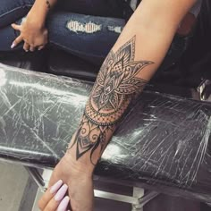 a woman's arm with a tattoo on it and an owl in the middle