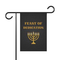 a black and gold jewish flag with the words feast of dedication on it