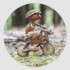 a small wooden toy riding a bike in the woods