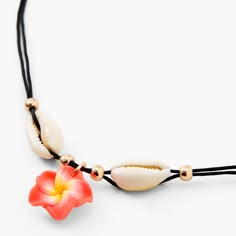 Tropical island style is obtainable with this pendant necklace. Cowrie seashells and a dangling hibiscus flower pendant give off island flair, and gold-tone finish helps it match the rest of your jewelry. Finish: Gold-tone Length: 16" + 3" extender Closure: Lobster clasp Material: Metal, Polyester - Claire's Black Cowie Shell & Hibiscus Flower Pendant Cord Necklace Summer Beach Flower Necklace With Charm, Summer Beach Flower Charm Necklace, Summer Beach Flower Necklace With Flower Charm, Gold Beach Jewelry With Flower Charm, Gold Jewelry With Flower Charm For Beach, Bohemian Flower Charm Jewelry For Beach, Gold Flower Jewelry For Beach, Adjustable Flower Pendant Necklace For Beach, Beach Flower Pendant Necklace