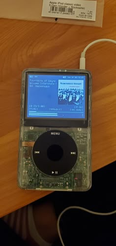 an ipod sitting on top of a wooden table