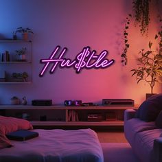 a living room filled with furniture and a neon sign on the wall that says hustle