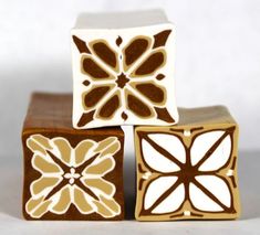 three decorative ceramic blocks sitting on top of each other