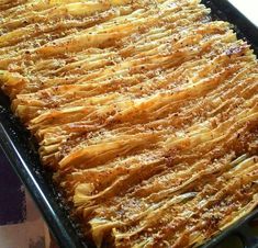 a pan filled with food sitting on top of a table