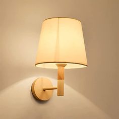 a wall light with a white shade on it