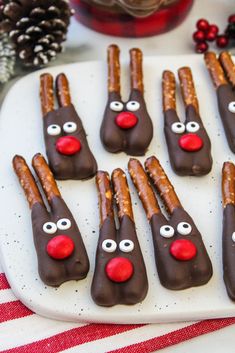 chocolate covered pretzels with reindeer noses on a plate