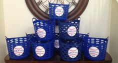 a group of blue baskets with baseballs on them sitting in front of a clock