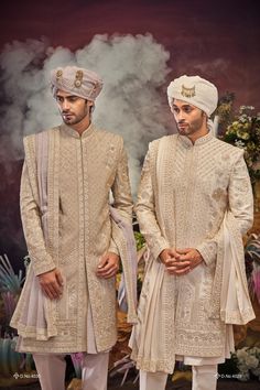 Make a grand statement on your special day with a luxurious Sherwani crafted from premium fabrics (like silk, brocade, or georgette) for ultimate comfort and sophistication. Our collection boasts a variety of designs to suit every taste: Classic elegance: Opt for a timeless Sherwani with intricate embroidery on the collar or cuffs. Modern flair: Go for a Sherwani with a unique neckline or a trendy color palette. Regal opulence: Choose a Sherwani with rich embellishments like zardozi work for a t Sarwani For Men Wedding, Traditional Fit Sherwani For Wedding And Diwali, Traditional Fit Bandhgala For Wedding, Wedding Sherwani For Diwali, Traditional Fit Sherwani With Pallu, Embroidered Traditional Fit Sherwani For Wedding, Brocade Sherwani With Naqshi For Diwali, Diwali Brocade Sherwani With Naqshi Details, Diwali Brocade Sherwani With Naqshi