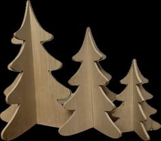 three wooden christmas trees sitting next to each other