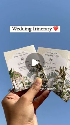 someone is holding up some cards in their hand with the words wedding itinery on them