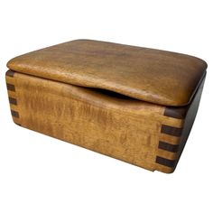 a wooden box sitting on top of a white surface